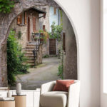 Fototapeten Charmante steinerne Gasse mit Torbogen